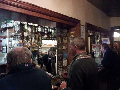 One side of the bar, accessible from the front hallway.