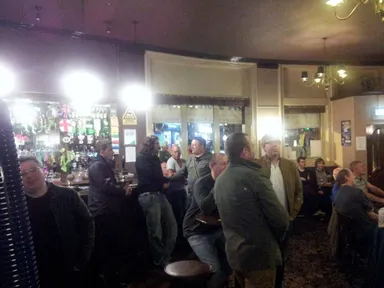 The bar, with most people facing the TV screen to watch the match.