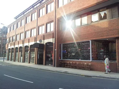 San Lucus occupies the ground floor of this incredibly dull building.