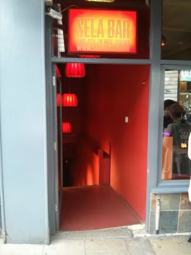 The entrance to Sela, with a glimpse of Wax Bar right next to it.