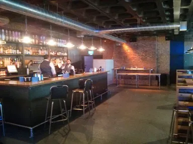 This is the bar area. Beer pong is at the back.