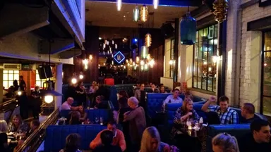 Lots of people eating on the restaurant floor.