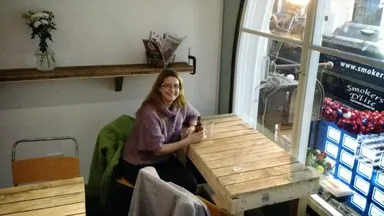 Emily looks out over the arcade, cradling a never-before-seen Founders DIPA.